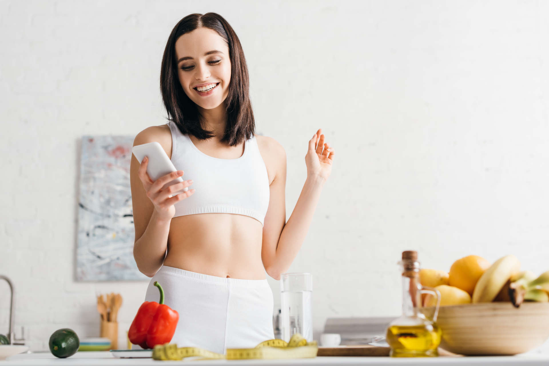 woman with lean belly using smartphone
